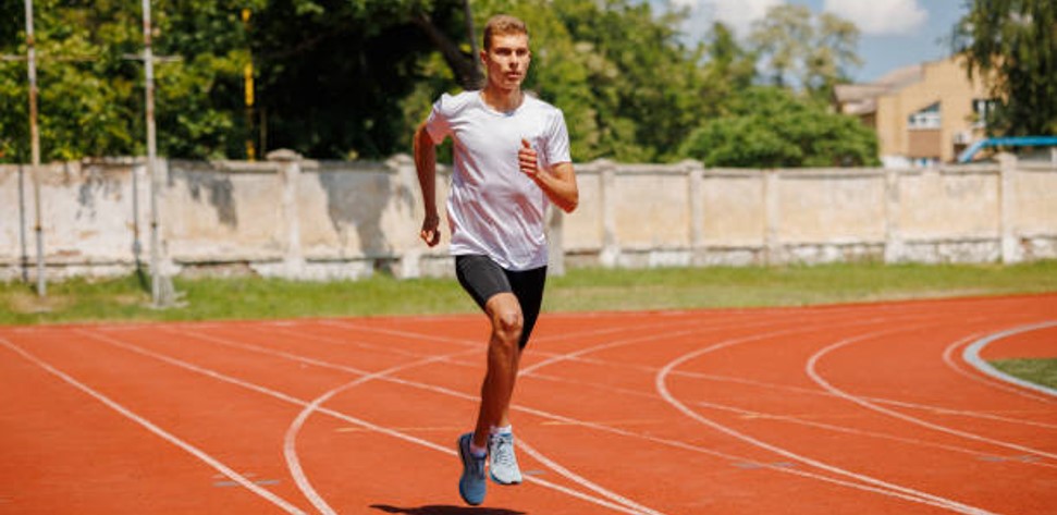 Coureur effectuant un test demi-Cooper sur une piste d'athlétisme